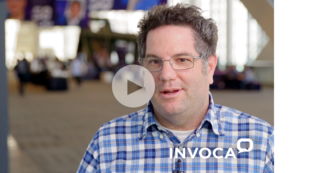 A still of a video featuring Ari Echt, Director of ABM at Invoca with a play icon superimposed on top of the image.